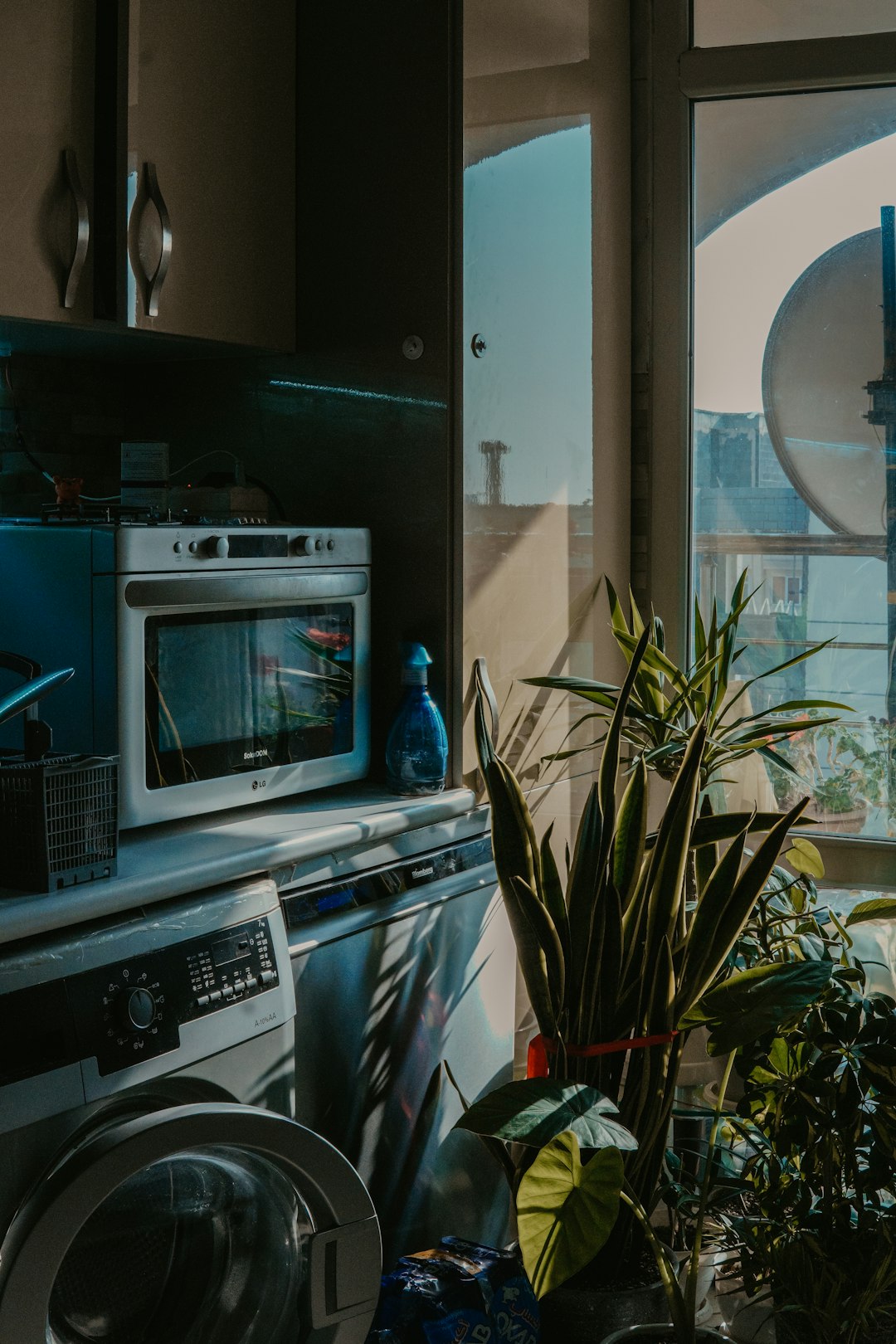 home-services-03 a-kitchen-with-a-washing-machine-and-a-window-zqxfmgdypm